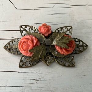 Stunning goldtone metal brooch with 3 coral roses, 1 small rose is made missing